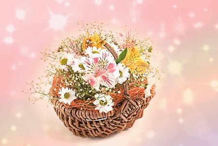 A basket of flowers on a beautiful blurred backgroundの写真素材