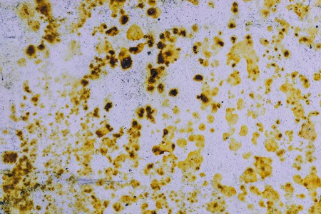 Background corrosion. Rusty spots on the metal sheet, the impact of atmospheric precipitationの写真素材
