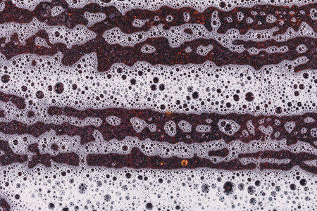 Suds and rust metal plate texture. Cleaning the surface of dirt
