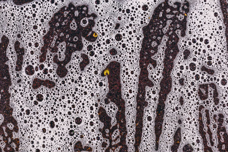 Suds and rust metal plate texture. Cleaning the surface of dirt