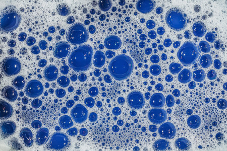 soap bubbles cleaning agent on the surface of the water