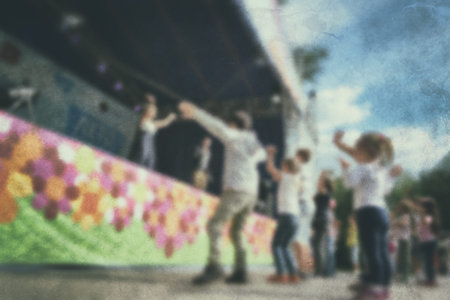 Old photo- blurred background people. Fast motion: active play - activities for children outdoors in...