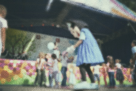 Old photo- blurred background people. Fast motion: active play - activities for children outdoors in the park.の写真素材