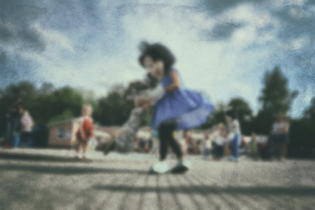 Old photo- blurred background people. Fast motion: active play - activities for children outdoors in the park.の写真素材