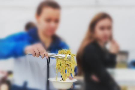 Blurred background with people: spaghetti laid out in a plate. Cook on the layout of the foodの写真素材