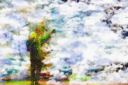 Blurred background of a winter landscape - people in the park to celebrate Christmas holiday. The performance of the artists on stage. Actors and musicians entertain the guests.の写真素材