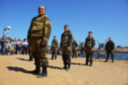 The river beach - blurred background. The combat exercises of the platoon special forces