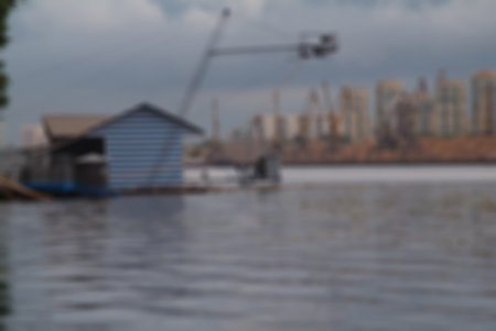 Blurred background active days on the river. Wakeboarding - riding people on the board through the water using rope.の写真素材