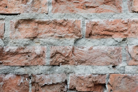Brick wall  background. Use as design element of residential and office interiors, rough, cracked roughness, the weathered masonry. Architecture abstract pattern.の写真素材