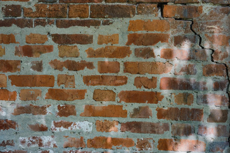Brick wall  background. Use as design element of residential and office interiors, rough, cracked roughness, the weathered masonry. Architecture abstract pattern.の写真素材