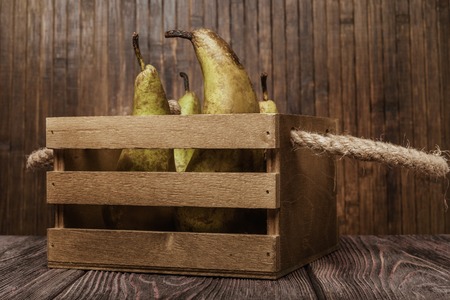 Still life- green pears in vintage box. The background of weathered wood.  It is possible to print large format.の写真素材