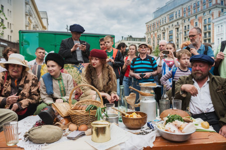 MOSCOW, RUSSIA - June 1-12, 2017: International festival "Times and epochs. The meeting". Scene from the life of a military town - the bandits at the holiday table. Great abundance of food during the famine.のeditorial素材