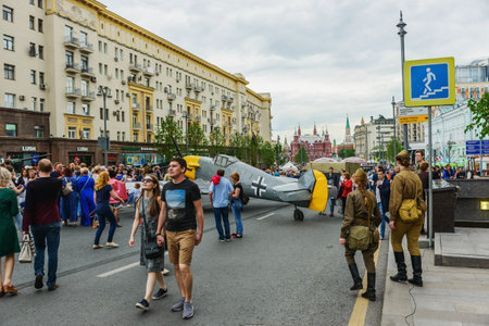MOSCOW, RUSSIA - June 1-12, 2017: International festival "Times and epochs. The meeting". Fun show - the crowd of people. Walk along Tverskaya street. In the background the Manezhnaya square and the Historical Museum.のeditorial素材