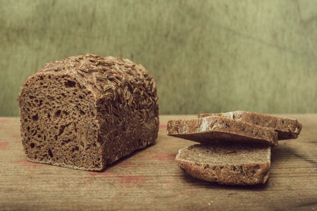 Natural background. Still life- cut slices of rye bread on a wooden tableの写真素材