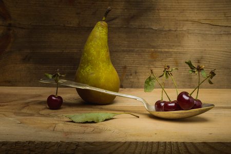 Still life- pear, cherry wooden background- autumn nature. Abstract scene for drawing objectsの写真素材