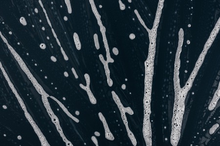 Texture liquid soap- drawing technique. Art fluid paint- cleansing wash. Creating abstract work- combinations of color, contrasts of smooth lines. Bubbles shampooの写真素材