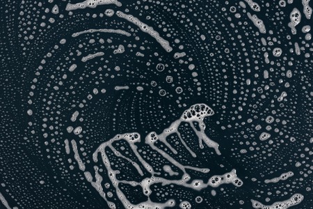 Texture liquid soap- drawing technique. Art fluid paint- cleansing wash. Creating abstract work- combinations of color, contrasts of smooth lines. Bubbles shampooの写真素材