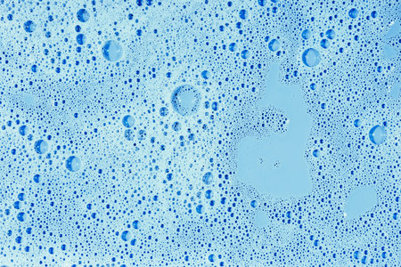 Soap bubbles- foam color background. Suds top view- liquid shampoo. Soapsuds- multicolor stains drip