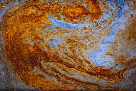 Fluid art. Abstract artwork- stain, splashes, smearing the dye. Liquid acrylic- color blot. Pigment water background- gold colorの写真素材