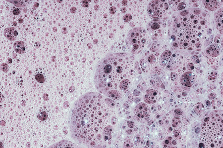 Soap bubbles- foam color background. Suds top view- liquid shampoo. Soapsuds- multicolor stains drip