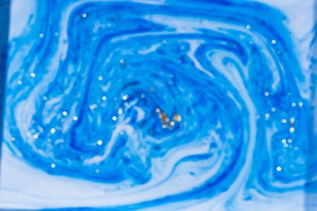 Fluid art- marbled effect. Abstract artwork- stain, splashes, smearing the dye. Liquid acrylic- color blot. Pigment water background- paint mixing.の写真素材
