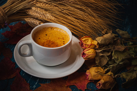 Still life- autumn motif. Breakfast- cup of coffee is on the table. Set of dishes and sweets