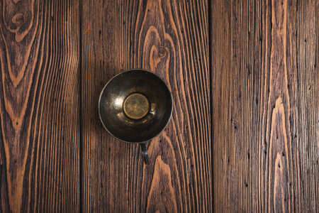 Low key photography- metal coffee cup on wooden backgroundの写真素材