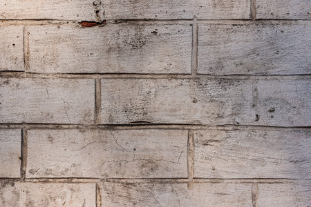 A ruined brick wall. Cracks, chips and other numerous damages. Texture- damaged material