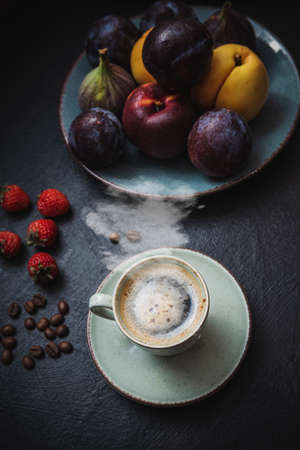 The morning treat is hot coffee and fruit on the table. Happy moodの写真素材
