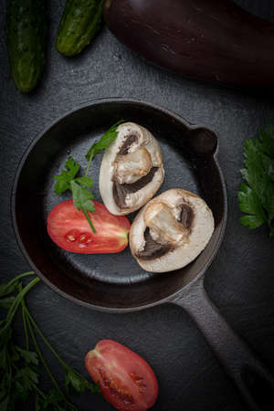 Cast-iron frying pan and a set of vegetables for cooking. Vegan breakfast- vegetarian foodの写真素材
