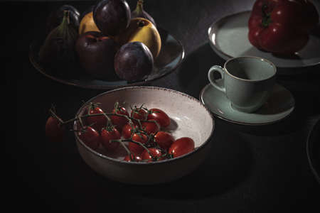 Tomatoes in a plate on the table. Food for vegans- cooking in the kitchenの写真素材