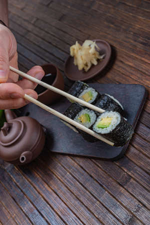 Japanese sushi - fast food. Asian traditional snack. Preparing healthy snackの写真素材