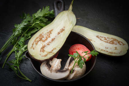 Cast-iron frying pan and a set of vegetables for cooking. Vegan breakfast- vegetarian foodの写真素材
