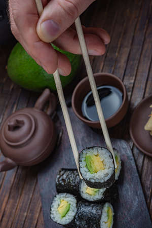 Japanese sushi - fast food. Asian traditional snack. Preparing healthy snackの写真素材
