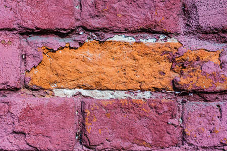 An old wall damaged- city building. Architecture- abstract background. Remnants of paint and plasterの写真素材