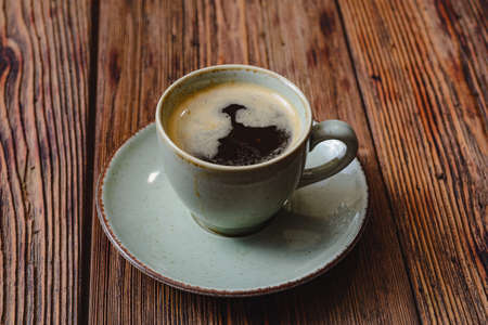 The morning treat- mug of hot coffee on a wooden board. happy moodの写真素材