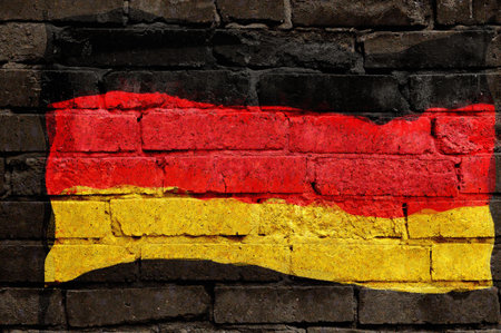 The national flag of the country is painted on a brick wall - graffiti. Exterior weathered...