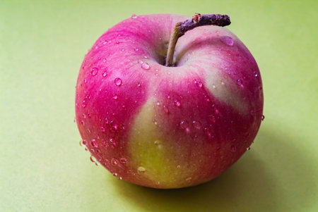 There are fresh dew drops on the apple. good mood vegetarian food