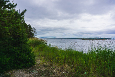 Landscape with lake, forest and cloudy sky. The Umba River on the Kola Peninsula. Tersky coast of the Murmansk regionの写真素材