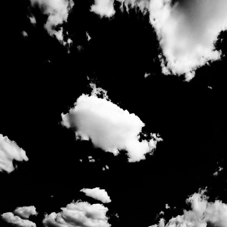 Set of isolated clouds over black background. Design elements. White isolated clouds. Cutout extracted clouds.の写真素材
