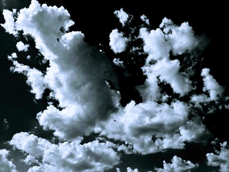 Isolated white clouds on black sky. Set of isolated clouds over black background. Design elements. White isolated clouds. Cutout extracted clouds.の写真素材