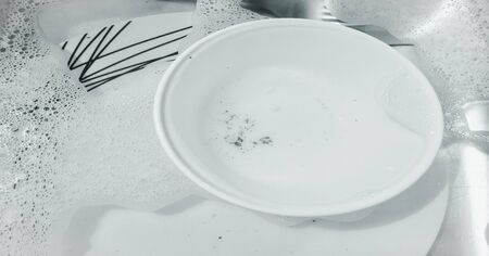 washing dishes, dishwasher. Washing kitchen ware on the sinkの写真素材