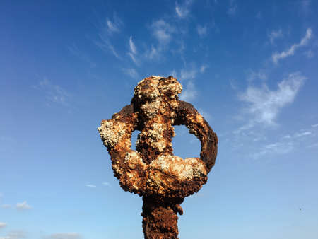 Rusty metal on blue sky with clouds backgroundの写真素材