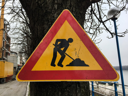 Road repair sign. Street road under construction. Road signs on the roadside along the road warning about the repairの写真素材