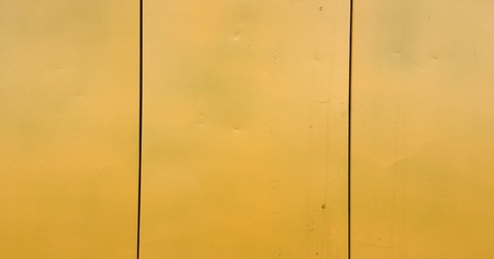 Rusty yellow painted steel metal. Stained rusty painted metal surface with flakesの写真素材