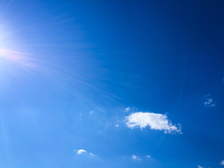Beautiful clouds against a blue sky background. Cloud sky. Blue sky with cloudy weather, nature cloud. White clouds, blue sky and sun.の写真素材