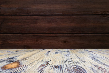 old painted washed oak wood table on the brown wood wall background, wooden table