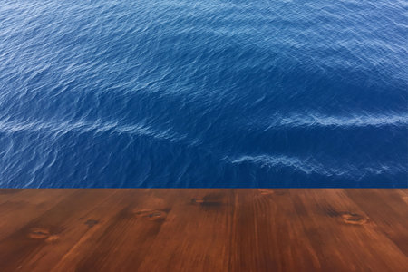 old brown oak wood deck table on the blue sea background, wooden tableの写真素材