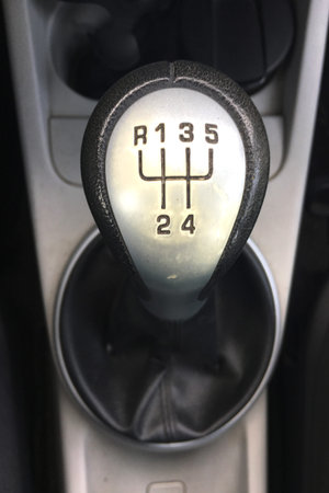 five-speed manual shifter in the car. Inside car, gear shifter close up