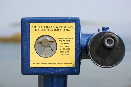 Telescope of dropping coins in an Island with lighthouse of a town of Irelandの写真素材